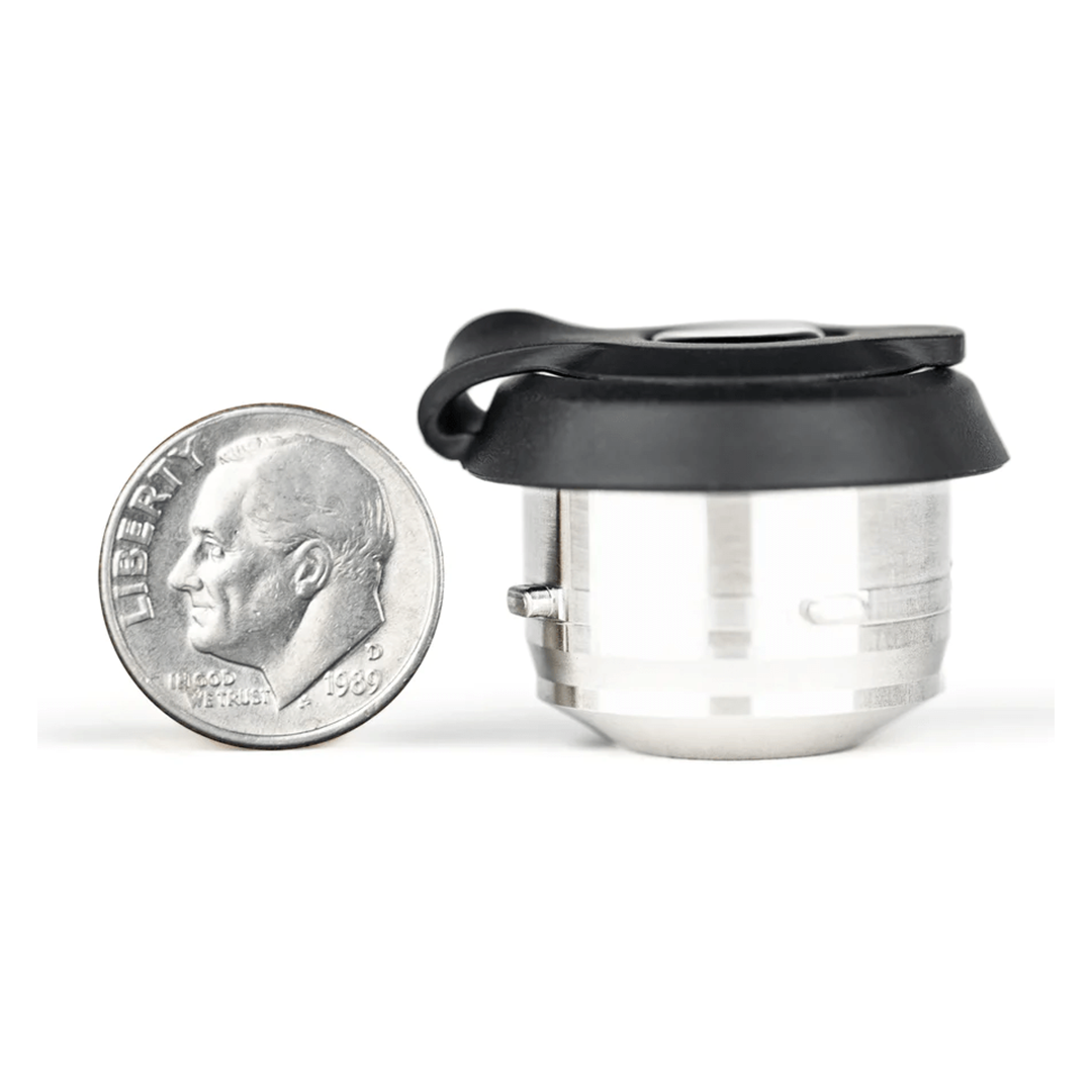 The puffco proxy 3d atomizer chamber replacement in black compared to the size of a dime